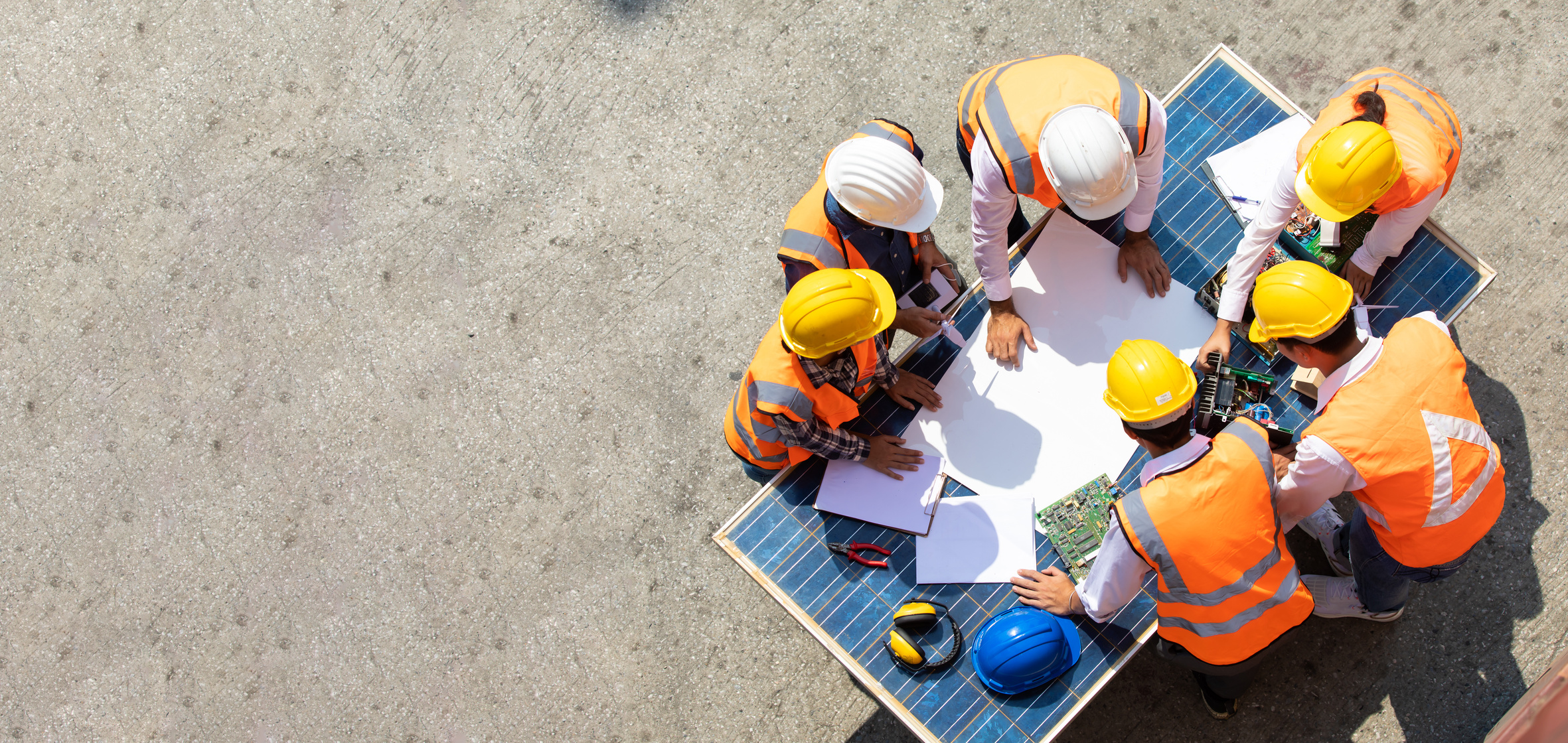 Group of professional engineering people wearing hardhat safety helmet meeting with solar photovoltaic panels discussion in new project by NVB Stocker